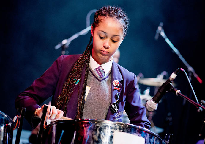 little girl playing the drums