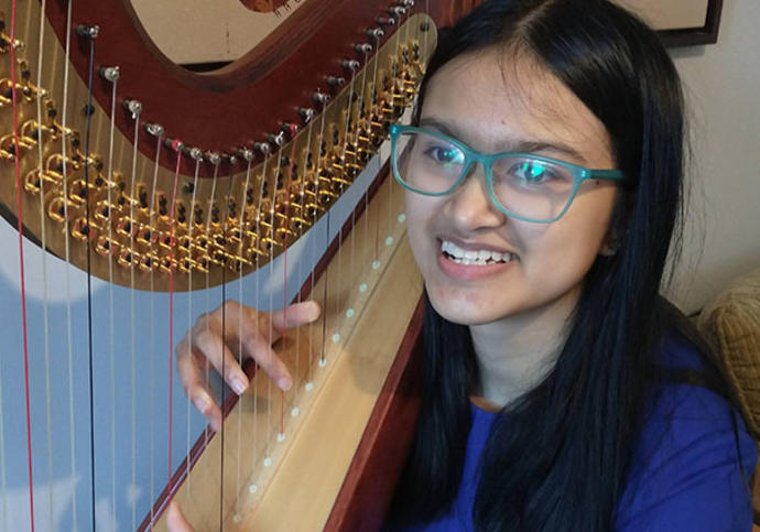 Smiling girl with a harp