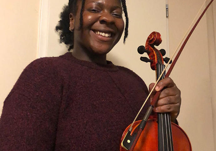 Woman smiling holding a viola