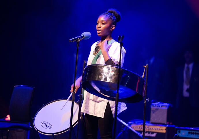 Young artist playing percussion instrument