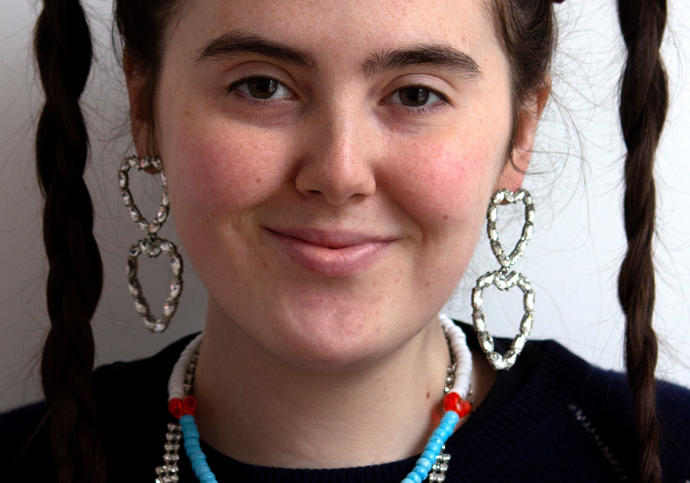 portrait of woman with long brown hair in 2 pigtails