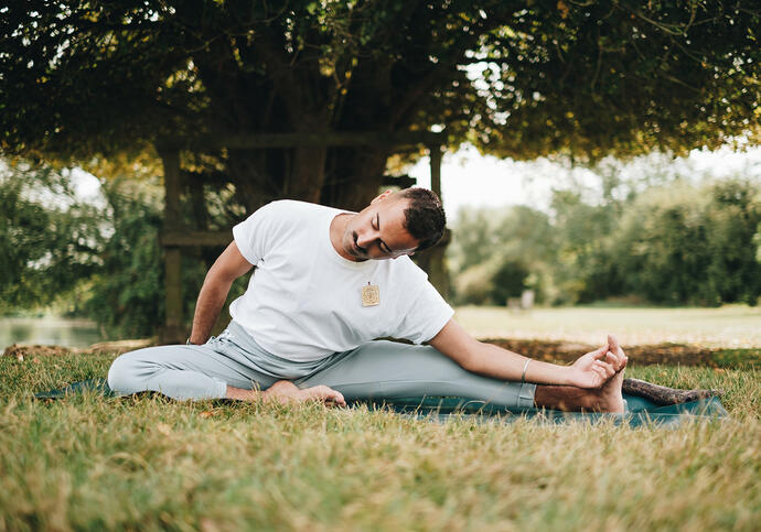 Person doing yoga in park