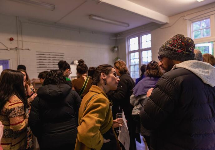 People gathered around a room talking to each other