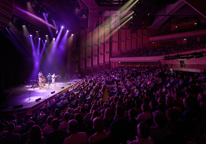 A purple glow comes from the spotlights at a concert in the Barbican Hall