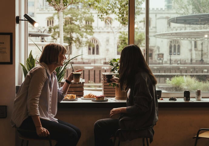 Two women enjoy coffee at Barbican Kitchen