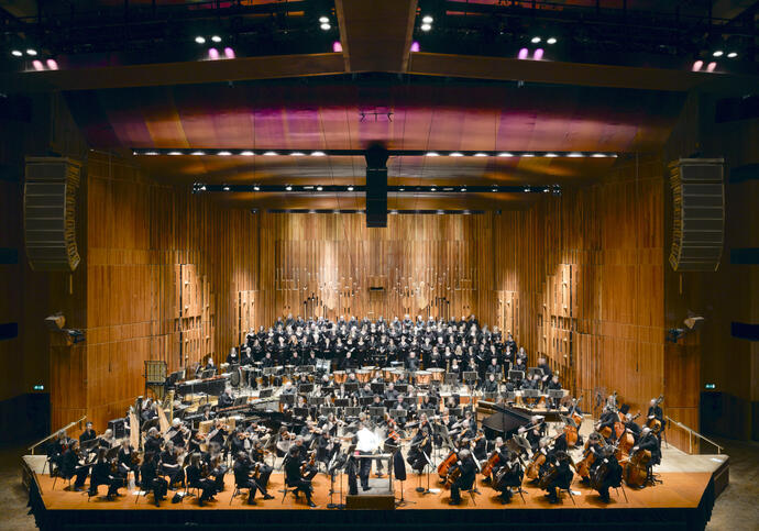 A photo of the Barbican Concert Hall with orchestra playing