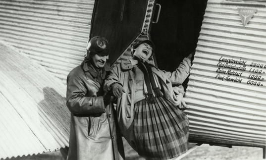A. Rodchenko and V. Stepanova descending from an airplane.