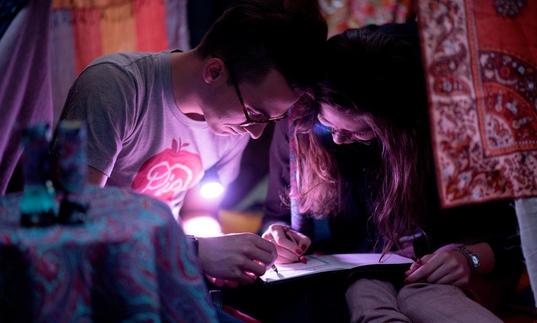 Photo of two people drawing 
