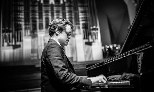 Benjamin Grosvenor playing piano black and white