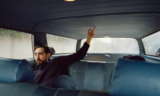 Charles Watson in a car with blue seats