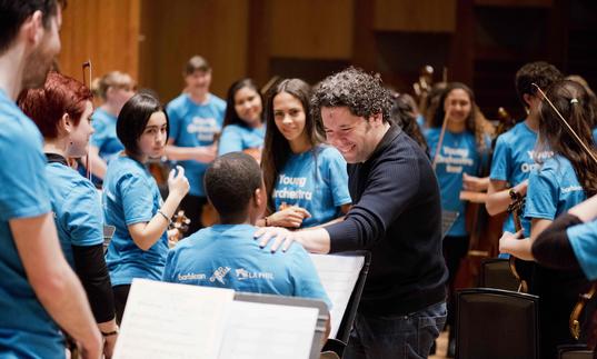 Gustavo Dudamel with young musicians from the Young Orchestra East