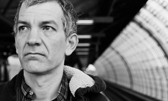 Brad Mehldau waiting for a train in black and white