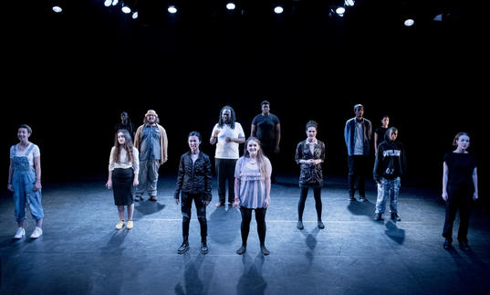 Group of young people standing on a stage