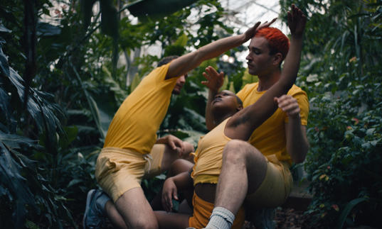 Three people in yellow dancing in Conservatory