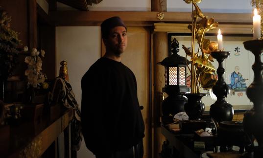 Tim Hecker standing in a temple