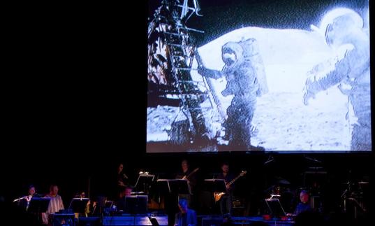 Icebreaker performing in front of footage from the Apollo moon landing