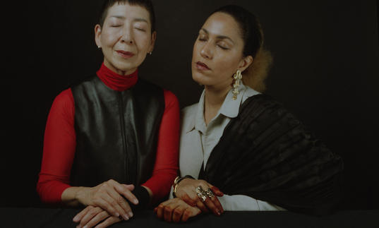 Midori Takada and Lafawndah sit side by side with their eyes closed