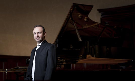Simon Trpceski standing near piano