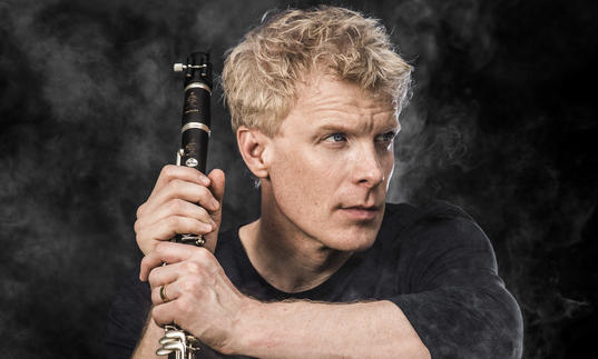 martin Frost holding clarinet smoke