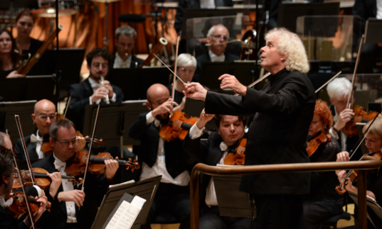 photo of simon rattle conducting