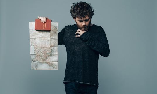 Gabriel Kahane holds up a map of North America