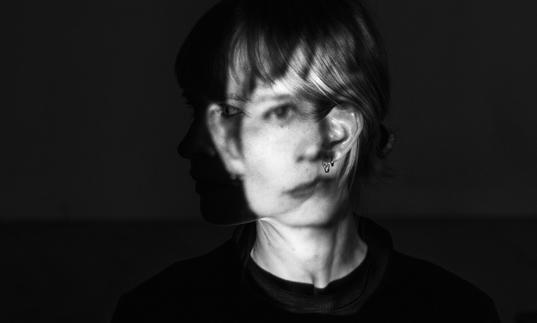 A black and white photo of Jenny Hval with her face distorted