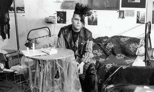 punk man sitting at a table