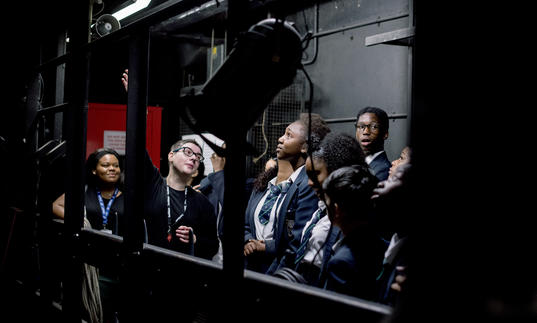 A group of school students backstage at the Barbican Theatre