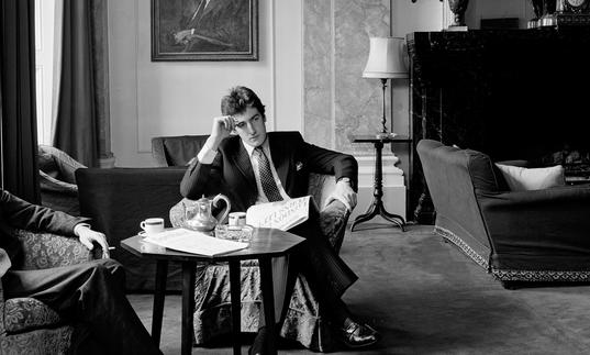 A black and white photograph of a well dressed, wealthy man looking despondent