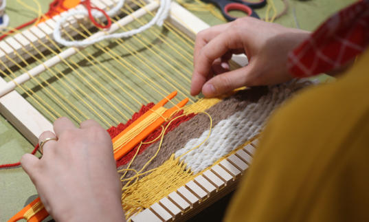 Woman using weave to make textile