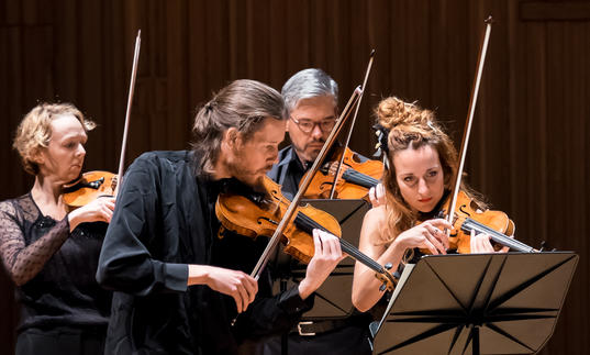 An image of the Britten Sinfonia musicians playing their instruments 