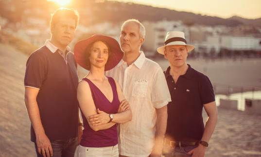 The Casals Quartet posing together as the golden Spanish sun sets in the background 