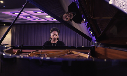 photo of isata kanneh-mason playing the piano