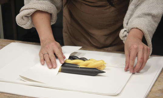 Woman sculpting beewax candle 