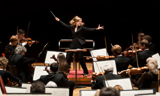 An image of Migra Gražintė-Tyla conducting the City of Birmingham Symphony Orchestra with great vigour