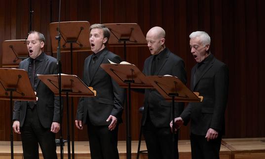 Four of the men of BBC Singers singing