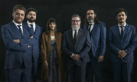 A portrait of Gustvao Santaolalla and his band