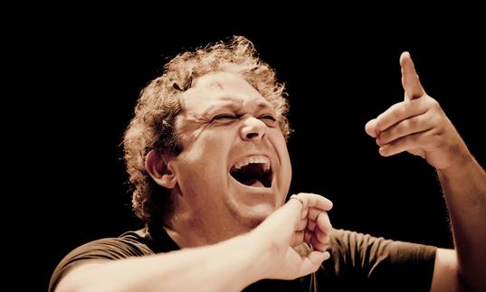 An impassioned Richard Edgarr conducting with an open mouth 