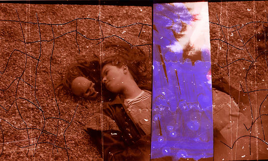A girl likes on a floor next to a skull, with a purple strip in A Different Category