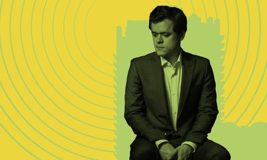 Benjamin Grosvenor looking pensive against an illustrated backdrop of the Barbican