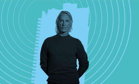 Paul Weller in front of a Barbican tower as radio broadcast signals emit from it