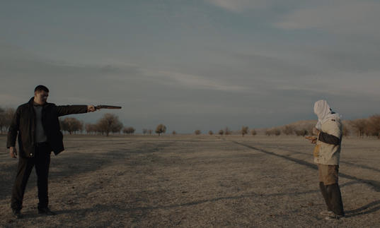 a man in black with a gun