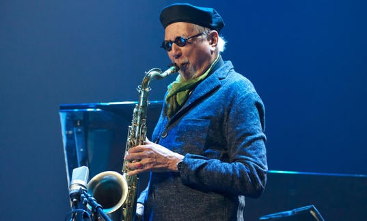 colour photo of Charles Lloyd playing saxophone