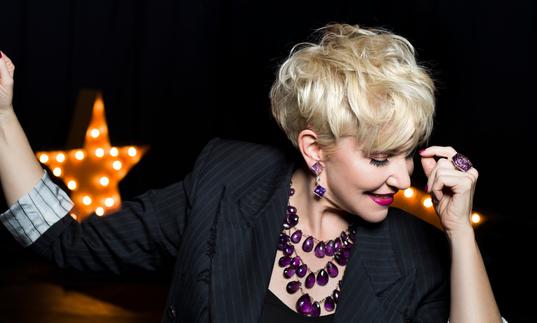 Joyce DiDonato smiling looking down at the floor