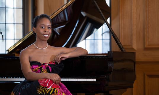 Samantha Ege sitting at a grand piano