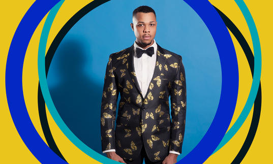 Davone Tines in front of a blue background, with BBC SO branding around the edges