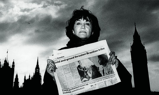 A woman holding a newspaper