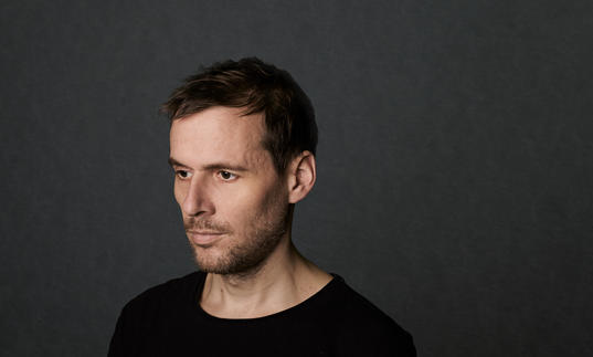 a photo od clark against a dark, plain background