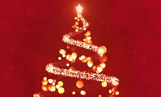 A gold Christmas tree on a red background, made out of light spots and sparkles