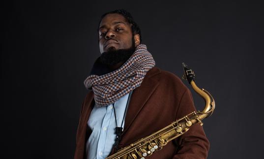 Soweto Kinch holding saxophone